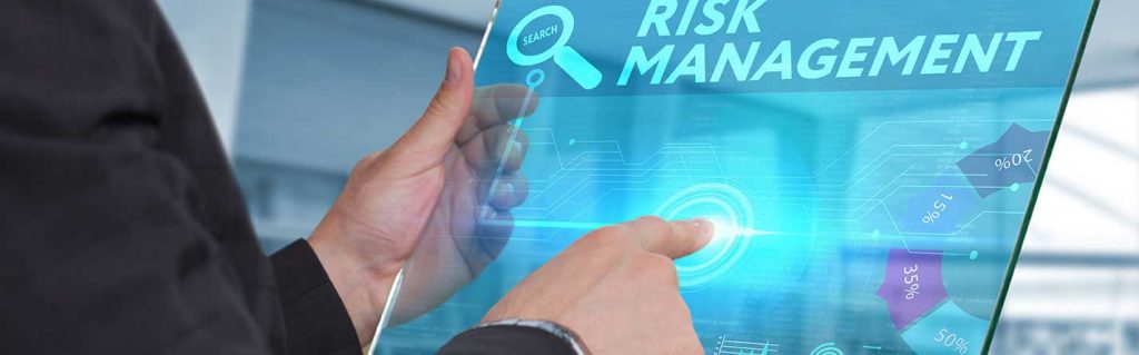 man standing in front of people sitting beside table with laptop computers